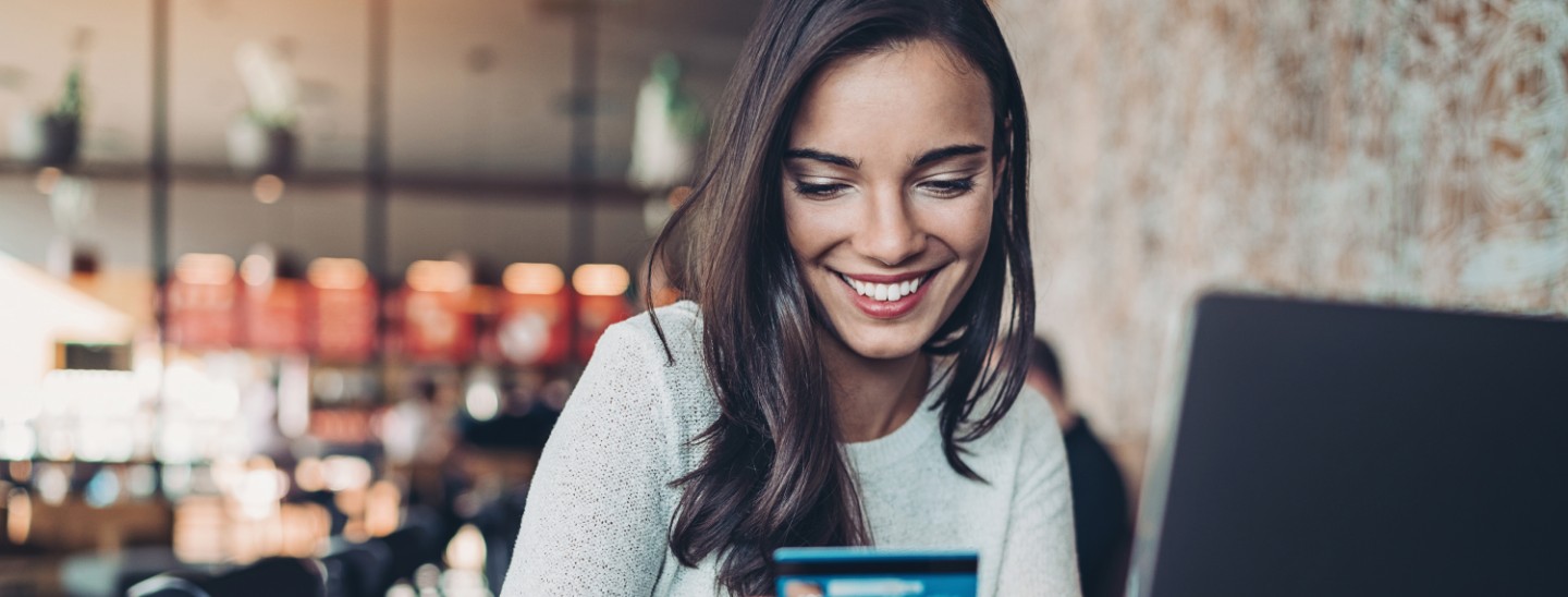 Off campus female holding credit card